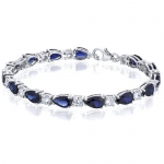 Perfect Allure: Pear Shape Blue Sapphire & White CZ Bracelet in Sterling Silver Rhodium Finish